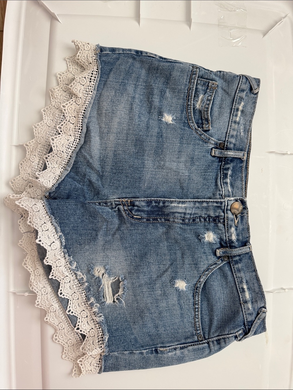 Free People Distressed Blue Denim Shorts with Cream Lace Trim